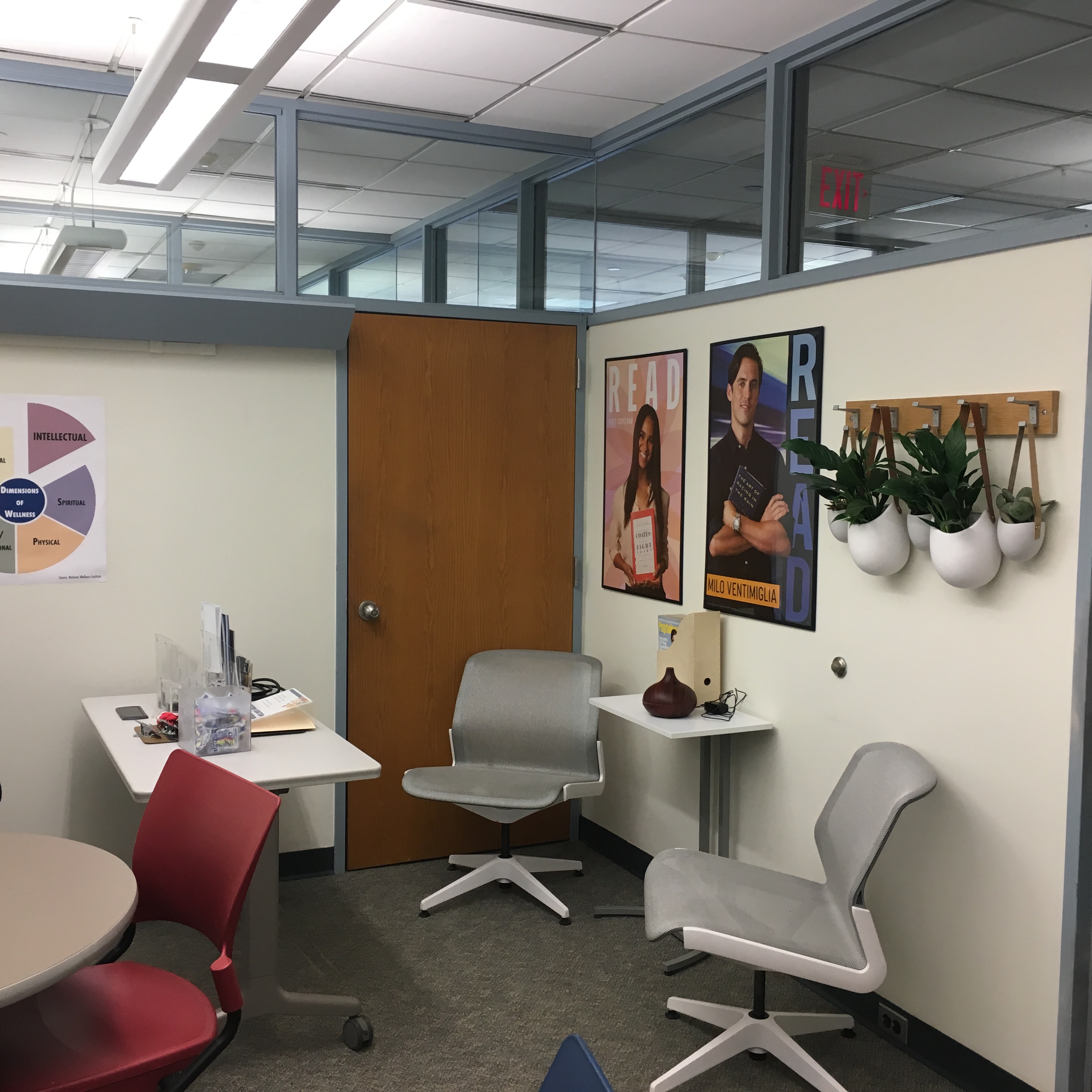 A room with two chairs and a small table with an aromatherapy macine on the table.