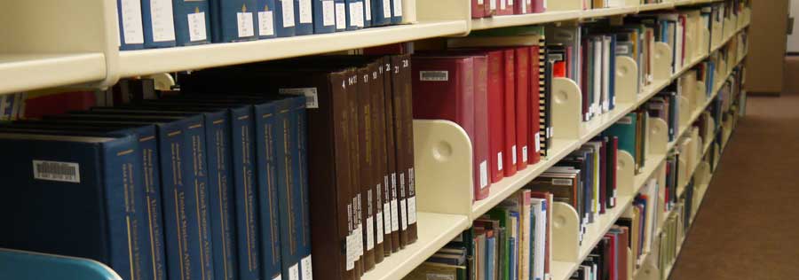 A shelf of books in the Drexel Libraries stacks.